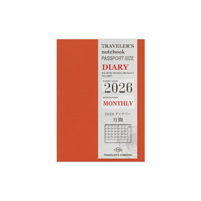 TRAVELER'S notebook Passport Size 2026 Monthly Planner insert. Shown orange card stock cover with label.