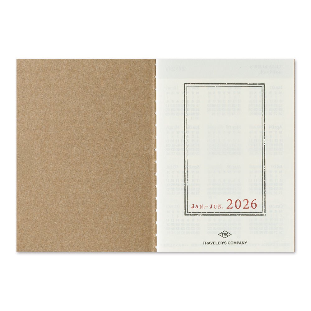 Blue TRAVELER'S notebook passport size 2026 planner with horizontal week over two pages layout showing the title page