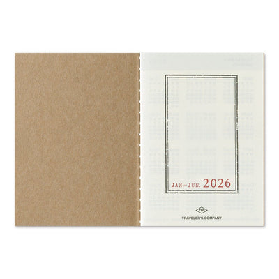 Blue TRAVELER'S notebook passport size 2026 planner with horizontal week over two pages layout showing the title page
